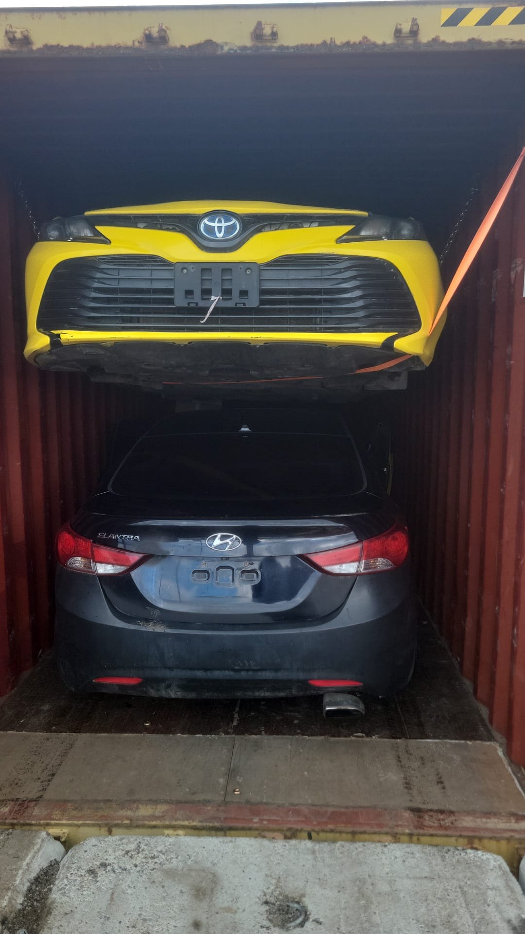 Two vehicles consolidated in one container